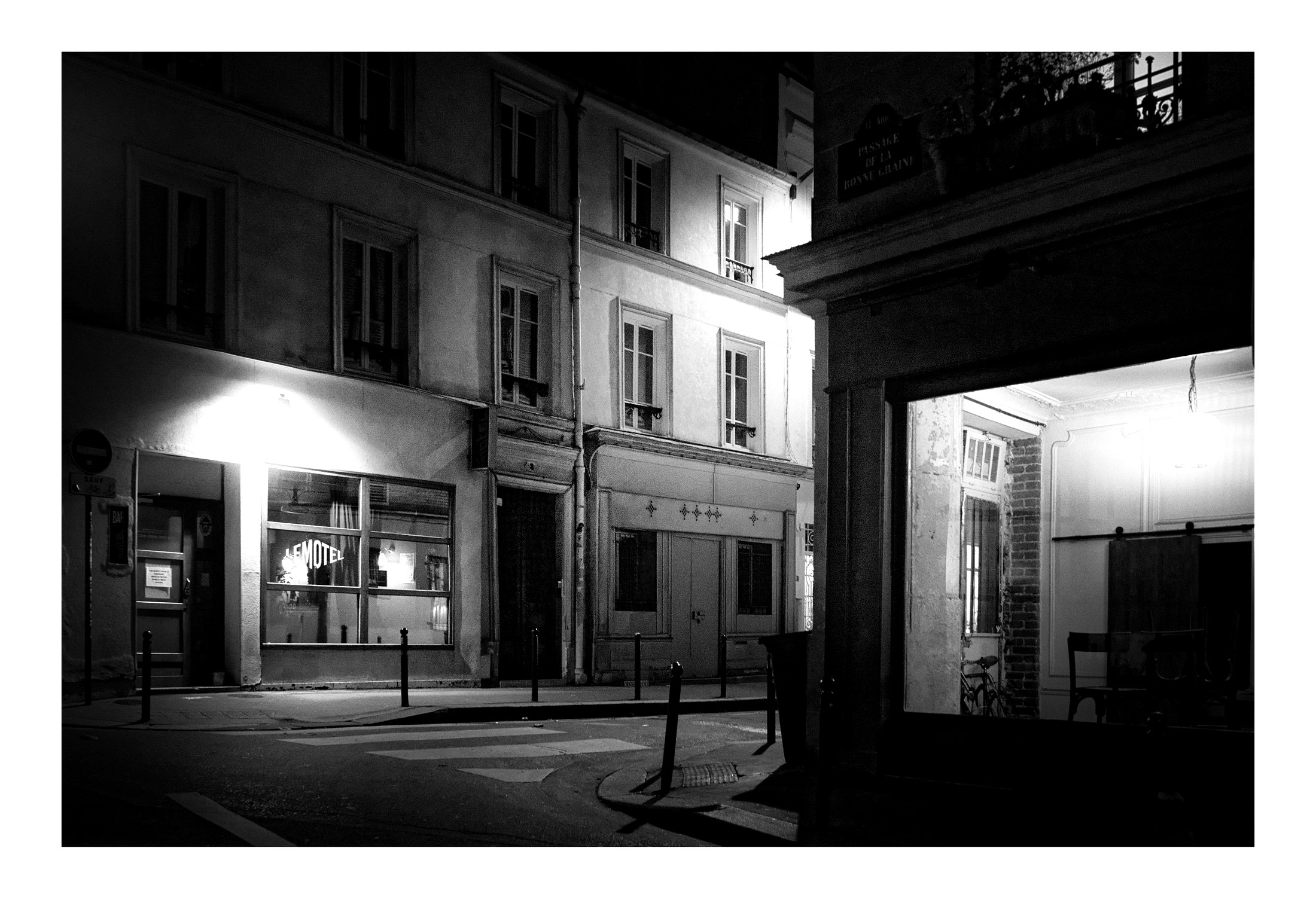 A black and white film noir street corner